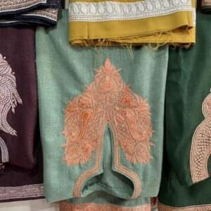 a bunch of different colored pants hanging on a wall