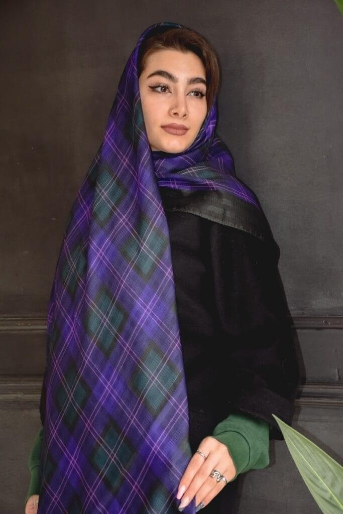 a woman wearing a purple and green plaid scarf